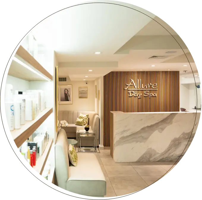 A woman receiving a facial treatment with a handheld device in a clinical setting while wearing a headband.