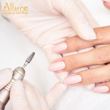 Professional manicure treatment with pink polished nails